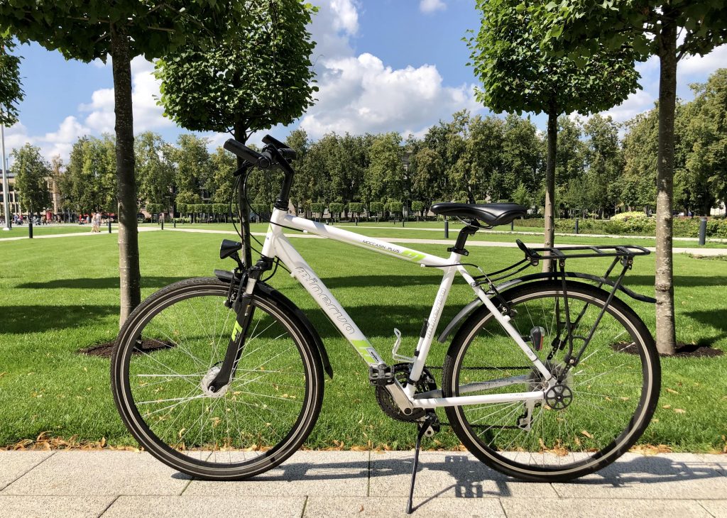 Hybrid bike Minevra in the background of the park in Vilnius for rent